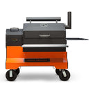 The Yoder Smokers YS640S Competition Pellet Grill with Wire Shelves features wheels, a right-side chimney, left control knobs, and side shelf for authentic wood-fired flavor. Branded "Yoder Smokers" on the front base.