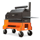 The Yoder Smokers YS640S Competition Pellet Grill with wire shelves features side shelves, a chimney, four wheels, and a sturdy base for authentic wood-fired flavor, proudly displaying the Yoder Smokers brand on the front.