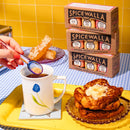 A hand adds sugar to tea on a yellow tray alongside French toast, rock candy, and Spicewalla spice boxes, all set atop a blue checkered tablecloth—an ideal scene for highlighting the Spicewalla 3 Pack Signature Sugar Collection and exploring new ways to enhance your breakfast with this delicious trio from Spicewalla.