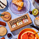 The Spicewalla 3 Pack Signature Sugar Collection by Spicewalla rests on a blue gingham tablecloth, surrounded by grapefruit, honeycomb, kiwi, cherries, chia pudding, brown sugar, cinnamon, and spoons.