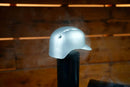 A silver Baseball Batting Helmet BBQ Chimney Cap - Silver | Pimp My Grill® sits atop a vertical pipe with smoke rising around it.