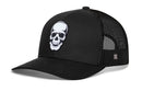 The Haka Hat Skull Trucker Hat in black features a white skull graphic on the front, curved bill, and mesh with a logo tag—perfect for Halloween or everyday wear.