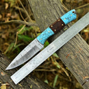 The Texan Knives Custom Handmade 5-Inch Small Hunting Knife by Texan Knives features a Damascus steel blade with an intricate pattern and a turquoise and wooden handle, displayed on a wooden surface beside a ruler showing its 5-inch length.