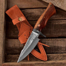 The Texan Knives Custom Handmade Small Hunting Knife features a Damascus steel blade and wooden handle, resting on a leather sheath—delivering exceptional outdoor performance from Texan Knives.