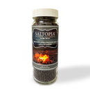 A clear jar of SALTOPIA Infused Sea Salts' Applewood Smoked Salt: GREAT OUTDOORS features a campfire label, beige lid, and dark brown granules that deliver authentic smoked sea salt flavor.