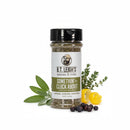A jar of B.T. Leigh’s Aromatic Citrus Herb Blend surrounded by fresh sage leaves, a sprig of thyme, a lemon peel, and juniper berries.
