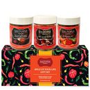 Three SALTOPIA Infused Sea Salts—Jalapeno Smoked Paprika, Hot Honey Blend, and Habanero—are displayed on the Saltopia Spice Lovers Gift Set box, which says: “Spice Up Your Life Gift Set. Bring Sizzle & Sass With Every Dash.”.
