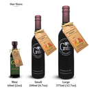 Three bottles of Georgetown Olive Oil Co Spicy Honey Pepper Balsamic, labeled mini (60ml), small (200ml), and large (375ml), are displayed with gold tags highlighting the product name. The sleek black bottles with gold accents and a Washington, DC address emphasize the premium quality of this Modena balsamic from Georgetown Olive Oil Co., infused with a hint of spicy honey pepper.