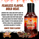 A bottle of Blazing Star BBQ Spicy Sauce by Blazing Star BBQ features bold text highlighting its fiery flavor and the intense heat of Carolina Reaper peppers, perfectly capturing the essence of a truly flavorful BBQ sauce. The playful cartoon pig logo adds a fun element, while images of food ingredients and grilled meat at the bottom emphasize this spicy BBQ sauce’s bold character.