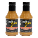 Two bottles of Gourmet Carolina Gold Spicy Hot Carolina Gold BBQ Sauce with black caps and black labels.