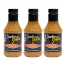 Three 18-ounce bottles of Gourmet Carolina Gold Spicy Hot Carolina Gold BBQ Sauce with black labels that read Spicy Hot Sauce.