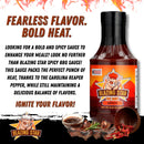 A bottle of Blazing Star BBQ Spicy Sauce by Blazing Star BBQ features bold text highlighting its fiery flavor and the intense heat of Carolina Reaper peppers, perfectly capturing the essence of a truly flavorful BBQ sauce. The playful cartoon pig logo adds a fun element, while images of food ingredients and grilled meat at the bottom emphasize this spicy BBQ sauce’s bold character.