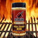Butcher BBQ Steak & Brisket Rub jar on a grill with flames in the background