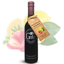 A dark wine bottle labeled “Georgetown Olive Oil Co.” displays a tag reading “STRAWBERRY LEMON Balsamic Vinegar | Barrel Aged, Modena ITALY.” This exquisite balsamic vinegar from Georgetown Olive Oil Co. is barrel aged in Modena, Italy and is presented with vibrant illustrations of strawberries and lemons behind the bottle.