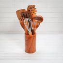 A Spice Wheel Acacia Wooden Spoon Set by Spice Wheel, featuring a wooden utensil holder with a variety of acacia wood kitchen tools, including wooden cooking utensils and a whisk, arranged on a white wooden surface with a white shiplap background.