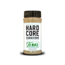 An 11 oz plastic jar of Hardcore Carnivore Texas Jalapeño Salt Seasoning (Limited Release) with a black lid, displayed against a plain white background. This keto-friendly seasoning by Hardcore Carnivore delivers the bold flavor of jalapeño salt, making it an ideal addition to your Texas-style barbecue dishes.