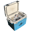 A Taiga Coolers 27 Quart Terra Pacific Blue Cooler sits open, filled with ice and canned drinks, while a fish design decorates its inside lid and cooler side.