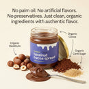 A jar of Taycte Taycte Organic Hazelnut Cocoa Cream is displayed with a spoonful of the luscious spread, whole organic hazelnuts, rich cocoa powder, and cane sugar artfully arranged nearby. The Taycte label emphasizes clean, organic ingredients and no artificial additives, making this chocolate spread a wholesome delight.