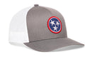 The Haka Hat Tennessee Flag Trucker Hat is a gray and white mesh snapback featuring a circular patch with three white stars on a blue background, trimmed in red, inspired by the Tennessee flag.