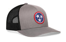 The Haka Hat Tennessee Flag Trucker Hat in gray and black features a snapback closure and a round front patch with three white stars in a blue circle, echoing the classic Tennessee flag design.