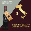 A bottle of Georgetown Olive Oil Co. Teriyaki Balsamic Vinegar with a Teriyaki tag, placed beside a gold map of Modena, Italy and the text “Premium Quality Aged Italian Balsamic.”.