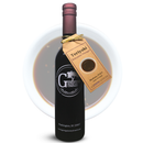 A bottle of Georgetown Olive Oil Co. Teriyaki Balsamic Vinegar by Georgetown Olive Oil Co. stands in front of a bowl filled with dark balsamic vinegar, with a tag on the bottle describing the product.
