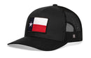The Haka Hat Texas Flag Trucker Hat is a black mesh snapback by Haka Hat, featuring a bold front patch of the Texas state flag with its iconic blue stripe, white star, and red and white stripes.