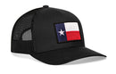 The Haka Hat Texas Flag Trucker Hat | Black TX Snapback features a black mesh design with a rectangular Texas flag patch on the front, combining comfort with classic Lone Star style.