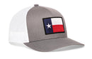 The Haka Hat Texas Flag Trucker Hat features a gray and white design, mesh back, adjustable snapback, and Texas flag patch on the front panel—perfect for showcasing your state pride.