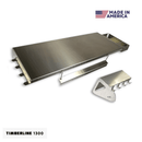 Pimp My Grill® Tactical Stainless Folding Front Shelf for the Traeger Timberline 1300, featuring a utensil hook rack and a Made in America logo.