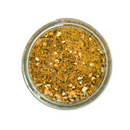 A top-down view of a glass jar filled with SALTOPIA Infused Sea Salts' Lemon & Herbs Seasoning Low Sodium: TWIST AGAIN, highlighting coarse yellowish-brown seasoning with visible herbs, set against a white background.