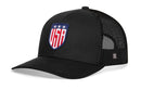 The Haka Hat USA Shield Trucker Hat is a black mesh snapback with a stitched USA shield and three white stars on the front, mesh sides and back, plus a small logo tag for classic style—perfect for showing off your American pride.