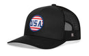 The Haka Hat USA Stripes Trucker Hat is a black snapback with a blue, red, and white "USA" embroidered patch on the front and breathable black mesh side and back panels.