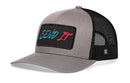The Haka Hat Send It Trucker Hat in gray-black features a comfort-fit sweatband and a front patch with “SEND IT” in blue and red stylized text.
