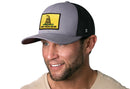 A man smiles while wearing a Haka Hat Dont Tread On Me Trucker Hat—Gray-Black Gadsden Flag Yellow Snapback.