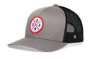 The Haka Hat USA Trucker Hat in gray-black features a circular America patch with "USA" and a star on red and blue crossed lines. Classic snapback trucker style for a patriotic look by Haka Hat.