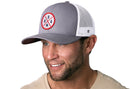 Man wearing a Haka Hat USA Trucker Hat—Gray-White America Snapback—with an embroidered patch and white mesh back.
