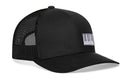 The Haka Hat Piano Keys Trucker Hat is a black snapback with a mesh back and a white patch on the front, featuring a black vertical stripe barcode design—bold style from Haka Hat combines classic trucker comfort with eye-catching detail.