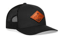 The Haka Hat Diamond Mountain and Trees Trucker Hat features a black mesh design, curved brim, and orange diamond-shaped leather patch with a sunburst and mountain motif—ideal for your next outdoor adventure.