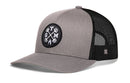 The Haka Hat GYM Trucker Hat in Gray-Black features a round patch with white crossed barbell and torch design, Y, G, and M letters, plus a comfy snapback fit and breathable black mesh—your perfect workout trucker hat.
