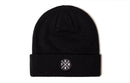 The Haka Hat Pacific Northwest Beanie | Black PNW X by Haka Hat is a black knit beanie with a folded brim and a white circular patch showing the letters P, N, W, and a pine tree. It’s displayed on a plain white background.