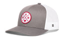 The Haka Hat Mom Trucker Hat in gray and white features a curved brim, mesh back, round red and white MOM patch with a heart, comfort-fit sweatband, snapback closure, and a small logo tag on the side from Haka Hat.