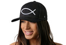 A woman with long brown hair smiles while wearing the Haka Hat Jesus Fish Trucker Hat, a black snapback featuring bold 3D ichthys embroidery by Haka Hat, against a plain white background.