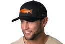 A smiling man wears a beige shirt and the Haka Hat Salmon Trucker Hat | Black Salmon Snapback by Haka Hat, featuring a premium salmon leather patch and comfort-fit sweatband, set against a white background.