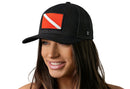 The Haka Hat Dive Flag Trucker Hat by Haka Hat is a black mesh snapback featuring a bold diver down flag—ideal for scuba diving fans and ocean lovers.