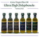 Six bottles from the Georgetown Olive Oil Co. 6 Bottle Variety Pack | Ultra High Polyphenols Extra Virgin Olive Oil are arranged in a row, each boasting distinct labels and clearly displayed polyphenol content. This collection from Georgetown Olive Oil Co. features a variety of Mediterranean flavors, making it an ideal choice for enhancing any dish.