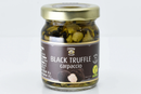 A glass jar of Taycte Black Truffle Carpaccio by Taycte, featuring a brown label with a vegan symbol and an image of sliced truffles on the front. The jar has a gold lid and contains thinly sliced Tuber Aestivum black truffles.
