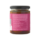 A glass jar with a black lid, containing Taycte Famiglia Crispino Sweet Tropea Onion Antipasto — IGP Certified Italian Red Onions. The reddish condiment inside is made from authentic Cipolle di Tropea IGP. The jar’s pink label, viewed from the back and slightly to the side, displays ingredients, nutritional information, and multilingual text. Celebrated as an authentic Italian antipasto by Taycte.