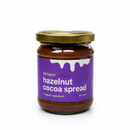 A glass jar of Taycte Taycte Organic Hazelnut Cocoa Cream by Taycte, featuring a gold lid and a purple label with white text and a drip design at the top—perfect for anyone who loves an indulgent chocolate spread.