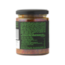 A glass jar with a black lid holds Taycte Famiglia Crispino Spicy Arrabbiata Bruschetta Spread — Hot Pepper Italian Antipasto, revealing a chunky, reddish paste studded with vegetable pieces. The vibrant green label from Taycte displays ingredients and nutritional details in multiple languages, evoking the bold flavors of authentic Calabrian bruschetta.